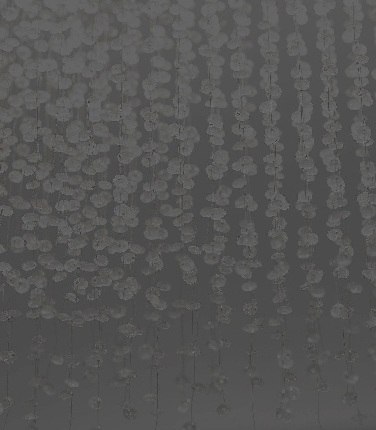 Hanging translucent beads with a dark background