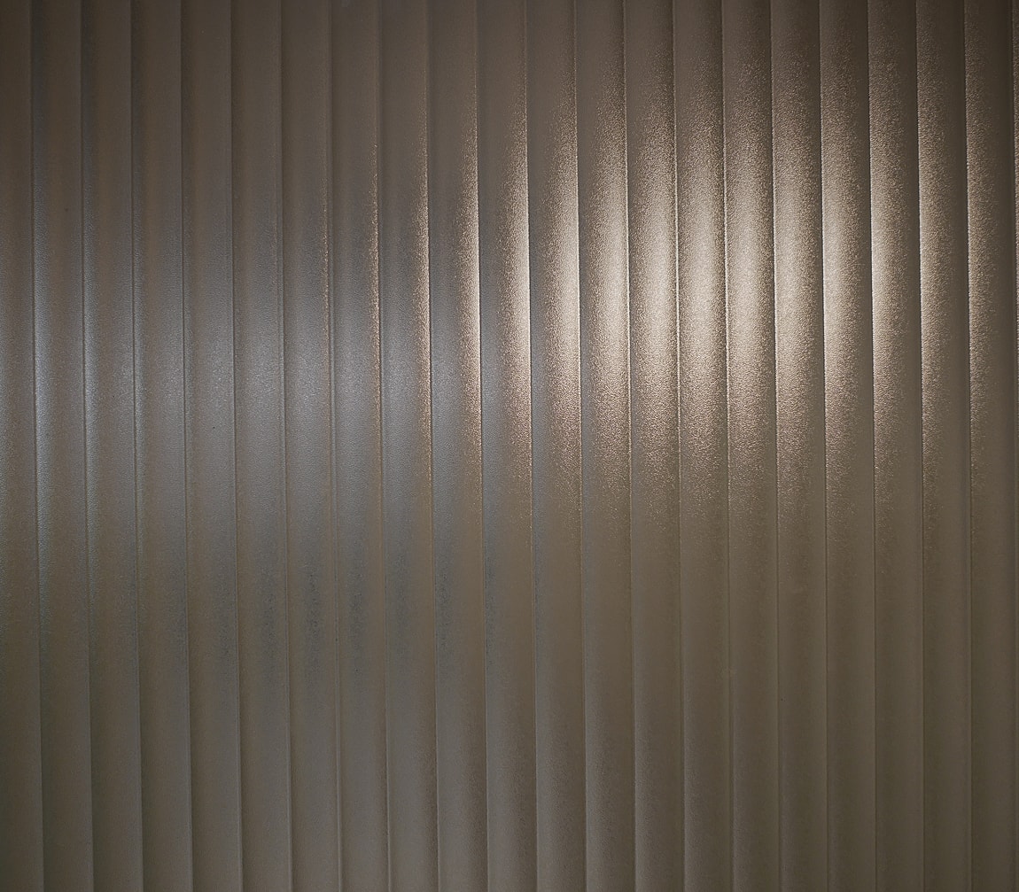 Fashion model in black outfit against light background.