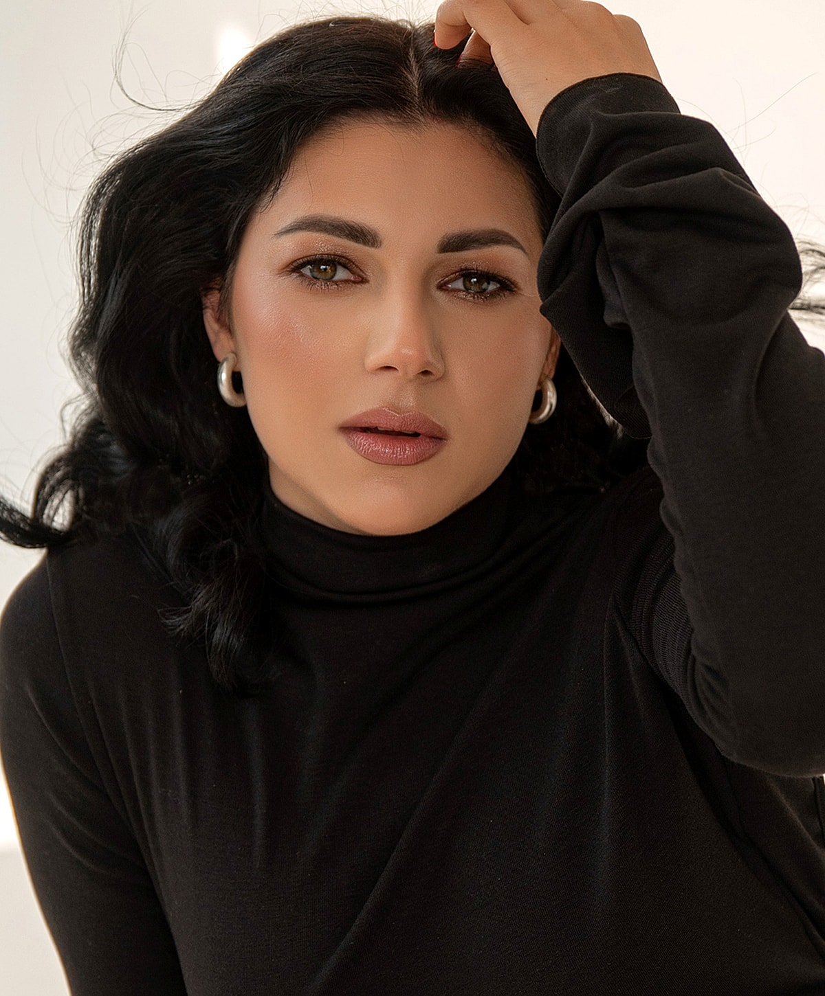 Portrait of a woman in a black turtleneck.