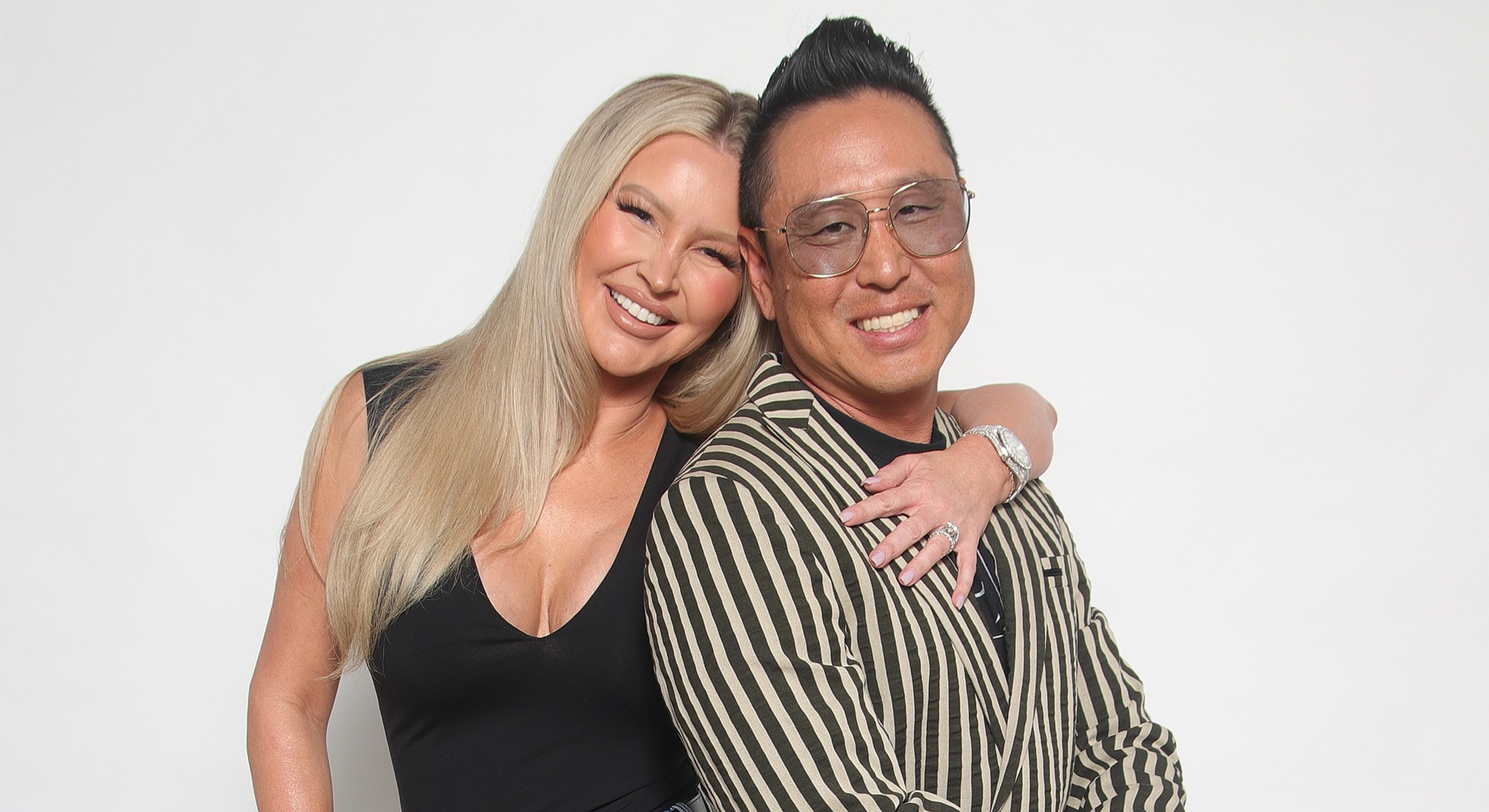 Two smiling people posing together.