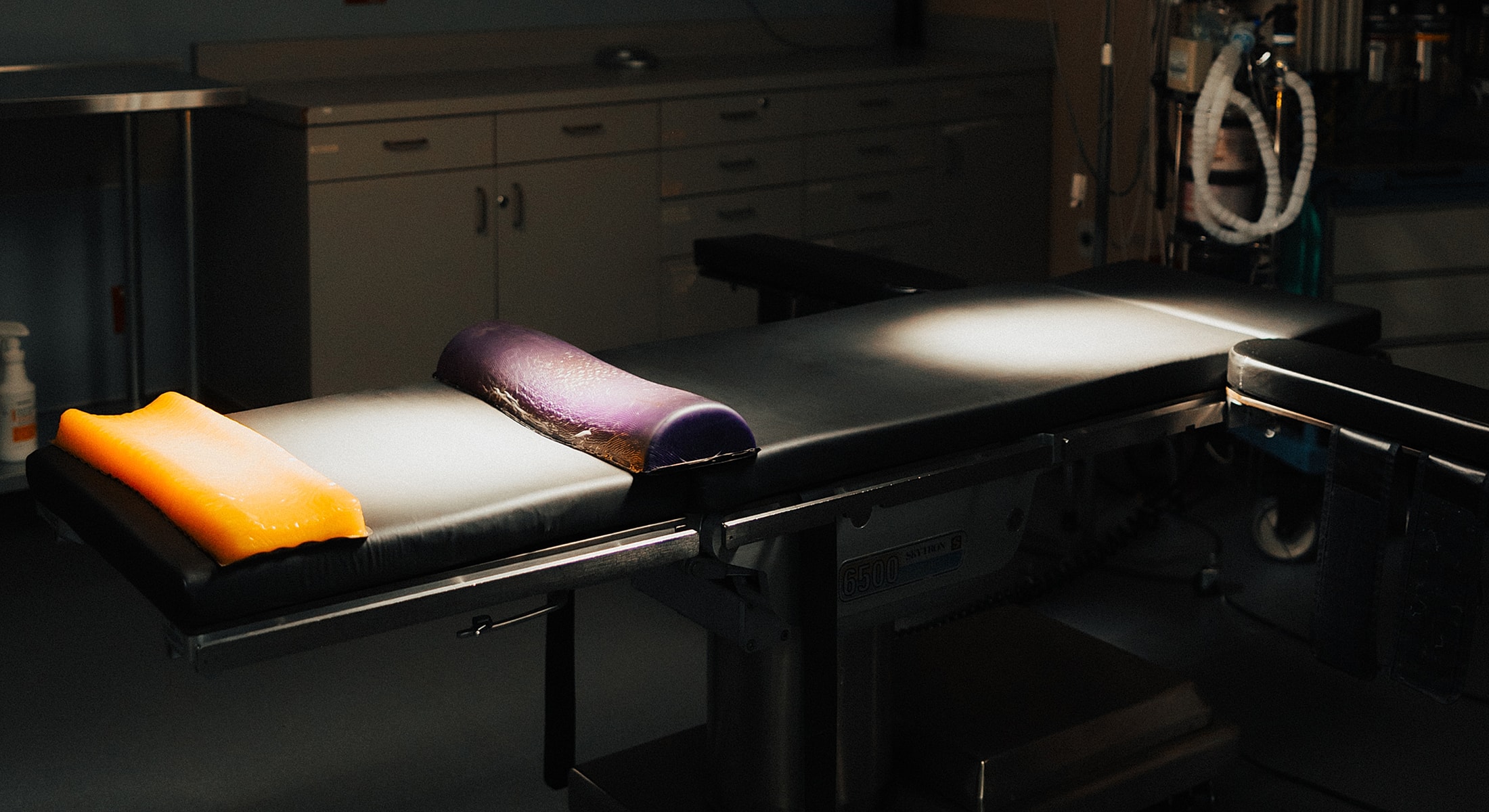 Medical examination table with colored pads.
