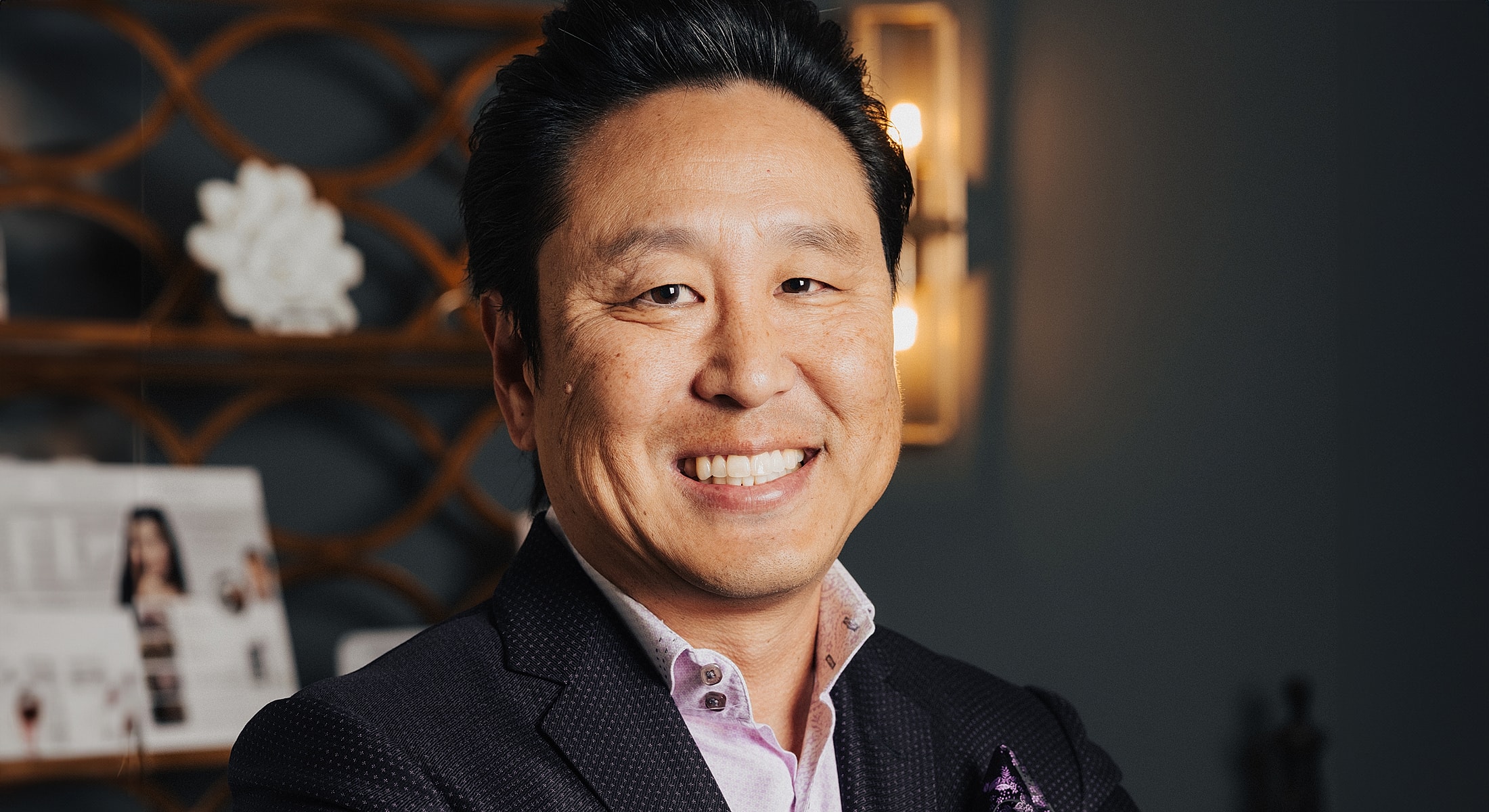 Smiling man in a suit with elegant background.