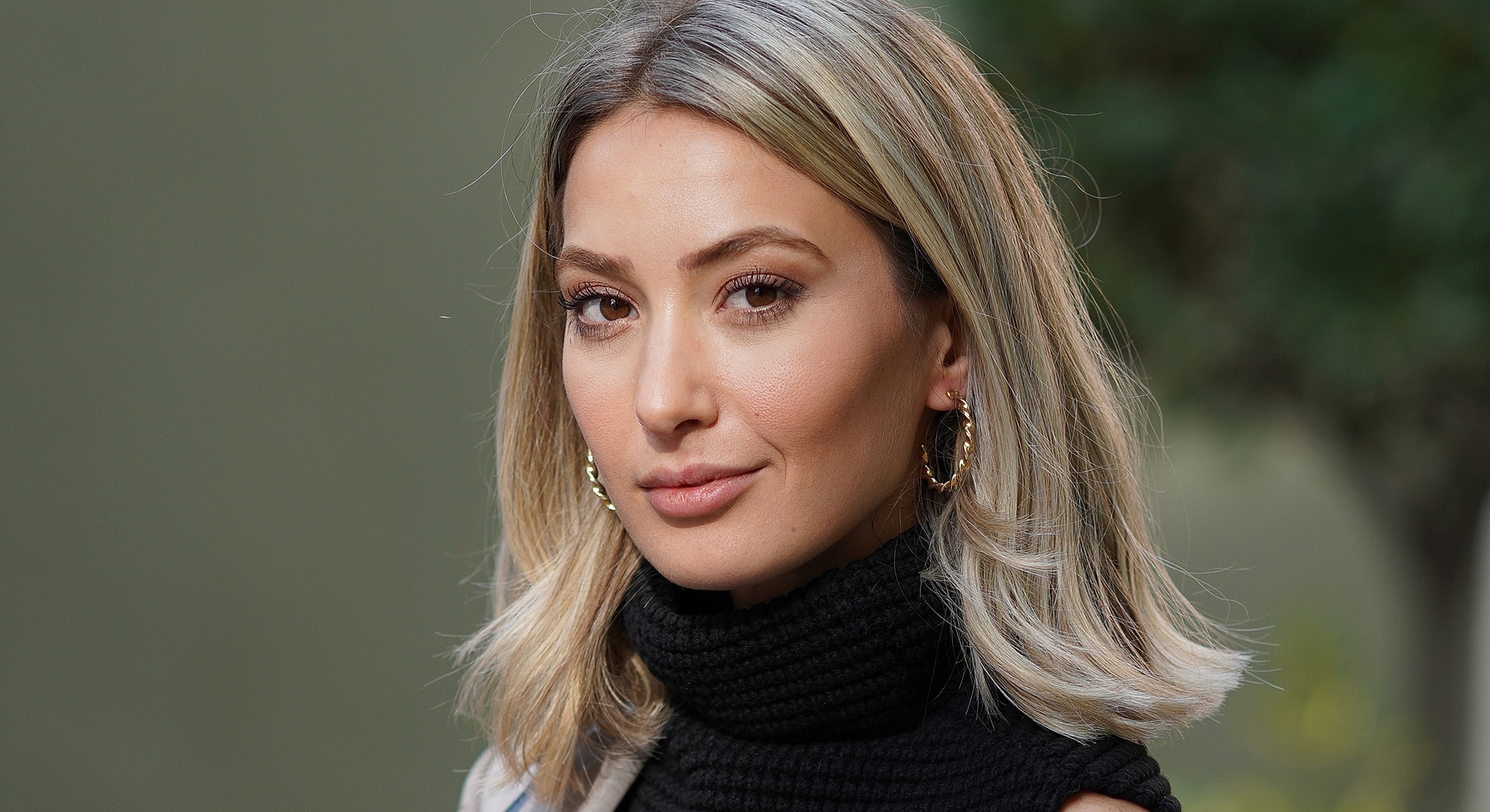 Woman with long hair and elegant earrings.