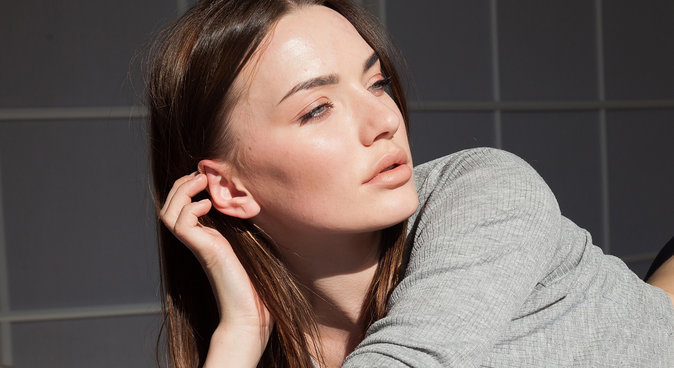Woman resting with light falling on her face.